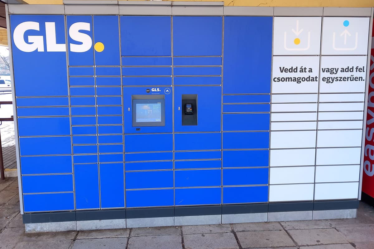 Blaue Paketstation eines Zustelldienstes an einer Hauswand